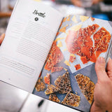 Open pages of The Cake Book showing a brittle recipe with crisp caramel and nut clusters by Crumbs & Doilies.